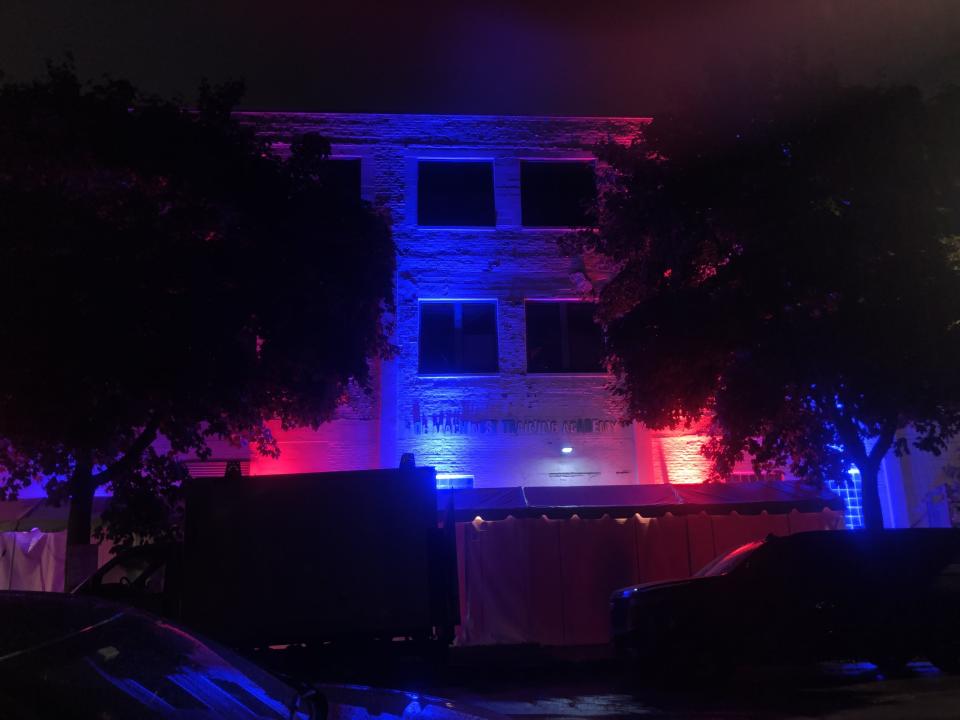 Red and blue lights illuminate a warehouse party at 1929 N. Buffum in Riverwest after the first night of the Republican National Convention.