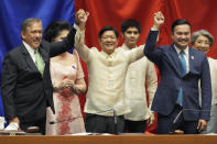 President-elect Ferdinand "Bong" Marcos Jr., center, raises hands with Senate President Vicente Sotto III, left, and House Speaker Lord Allan Velasco during his proclamation at the House of Representatives, Quezon City, Philippines on Wednesday, May 25, 2022. Marcos Jr. was proclaimed the next president of the Philippines by a joint session of Congress Wednesday in an astonishingly huge electoral triumph 36 years after his father was ousted as a brutal dictator by a pro-democracy uprising. (AP Photo/Aaron Favila)