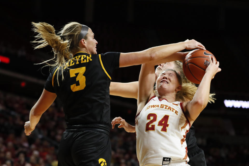 Iowa guard Makenzie Meyer, left, blocks a shot by Iowa State guard Ashley Joens (24) during the first half of an NCAA college basketball game, Wednesday, Dec. 11, 2019, in Ames, Iowa. (AP Photo/Charlie Neibergall)