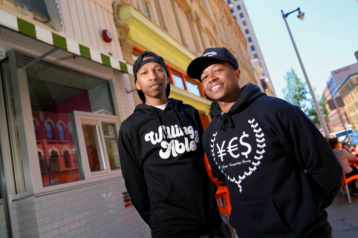 Que El-Amin, left, and his brother Khalif El-Amin founded the Young Enterprising Society, a Milwaukee group that’s exposed students to career and business opportunities in a part of the city that’s been overlooked. They’re seen on North Milwaukee Street,  in Milwaukee, on Thursday, July 14, 2022, in an area when some of the first meetings to start the group happened.