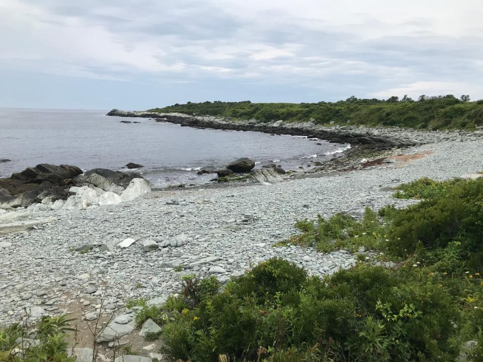 The crescent-shaped rocky shoreline curls south along the perimeter trail that hugs the scenic coast at Sachest Point National Wildlife Refuge in Middletown.