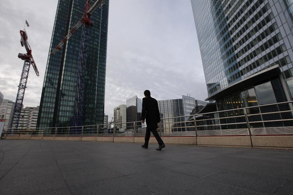 A man walks in the business district of La Defense in Paris, Tuesday, Nov. 20, 2012. In a setback for President Francois Hollande's Socialist government, Moody's Investors Service stripped Europe's No. 2 economy of it of its prized AAA credit rating late Monday on concerns that its rigid labor market and exposure to Europe's financial crisis were threatening its prospects for economic growth. (AP Photo/Francois Mori)