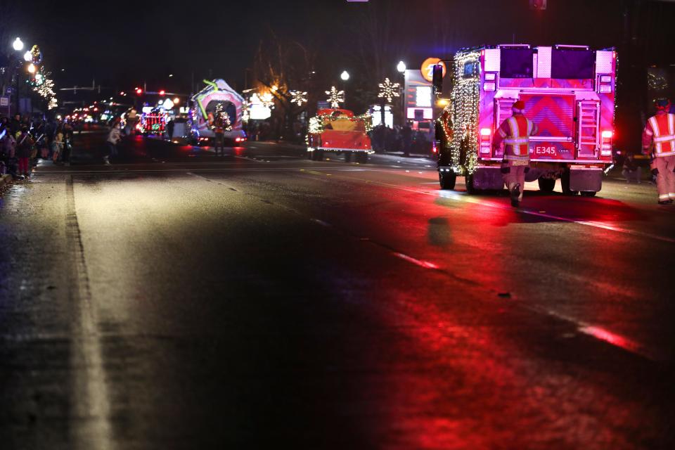 Floats and vehicles drive on River Road during the Keizer Holiday Lights Parade in 2021.