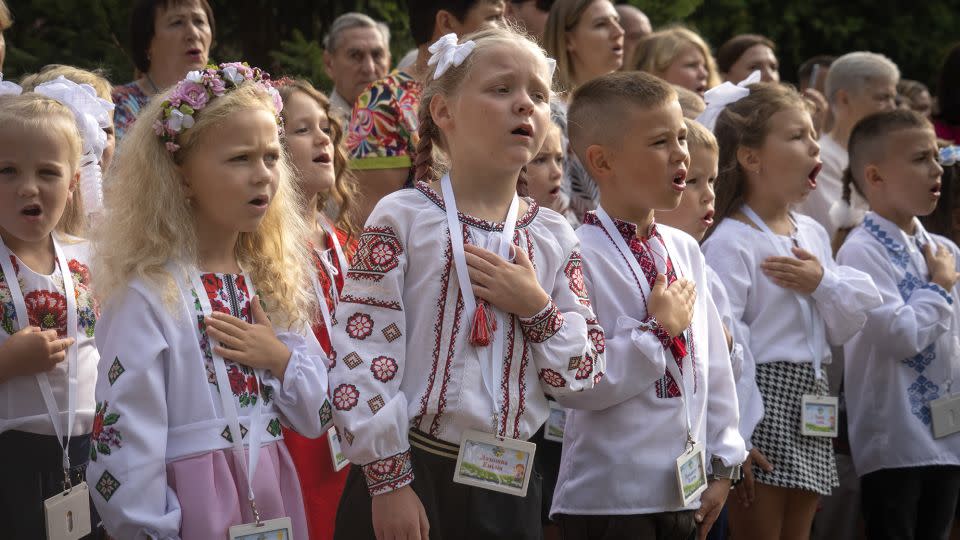 Students sing Ukraine's national anthem as they attend a ceremony of the first day in school in Bucha, on Friday. - Efrem Lukatsky/AP