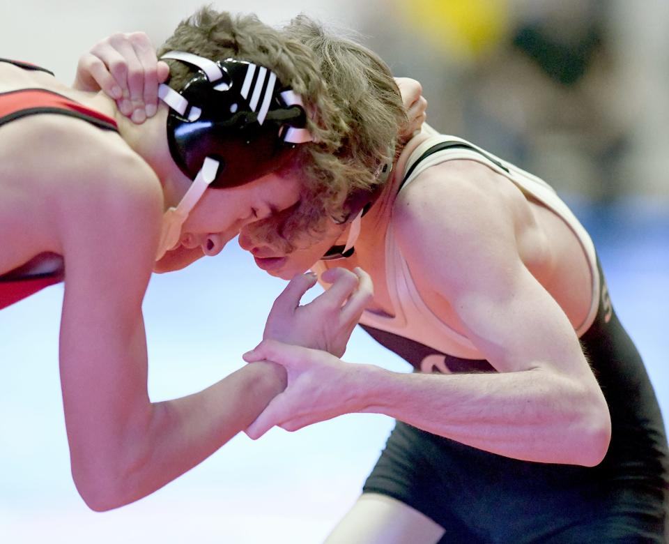 St. Thomas Aquinas' Andrew Grecol competes against Milford's John Steiner in a 132-pound first round match at the McKinley Top Dawg Wrestling Invitational on Wednesday..