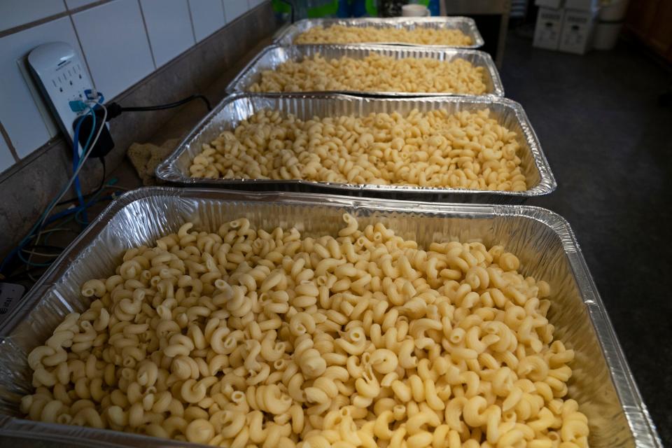 Pans of pasta await the cheese for mac and cheese that will be served as the fish fry resumes Friday, March 4, 2022 at Sweetest Heart of Mary Church in Detroit. Volunteers work on preparing for the fish fry on March 2, 2022.