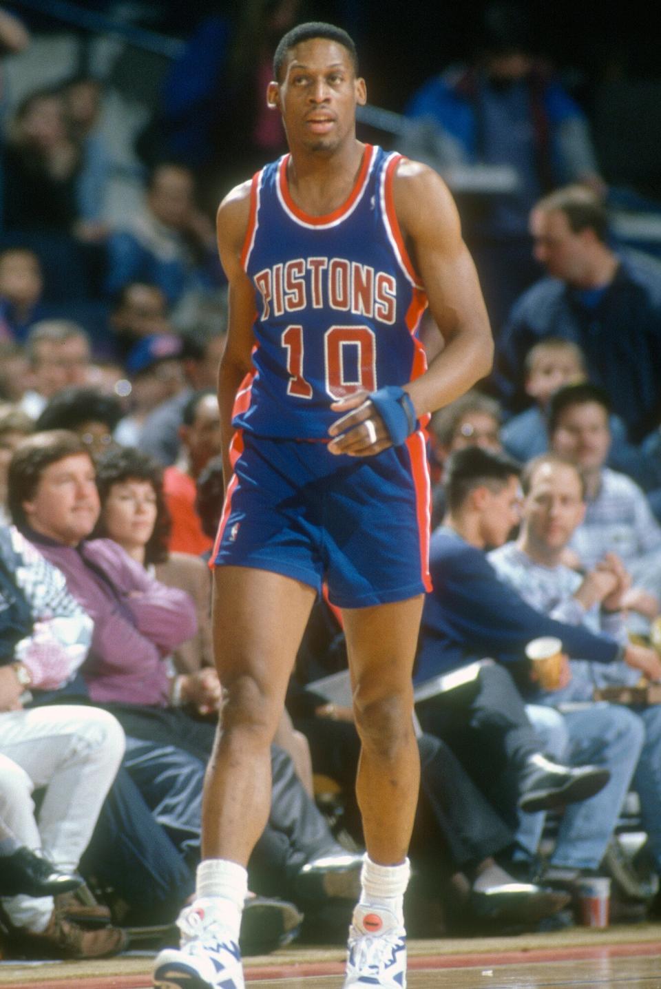 Dennis Rodman #10 of the Detroit Pistons walks up court and looks on against the Washington Bullets during an NBA basketball game circa 1992 at the Capital Centre in Landover, Maryland