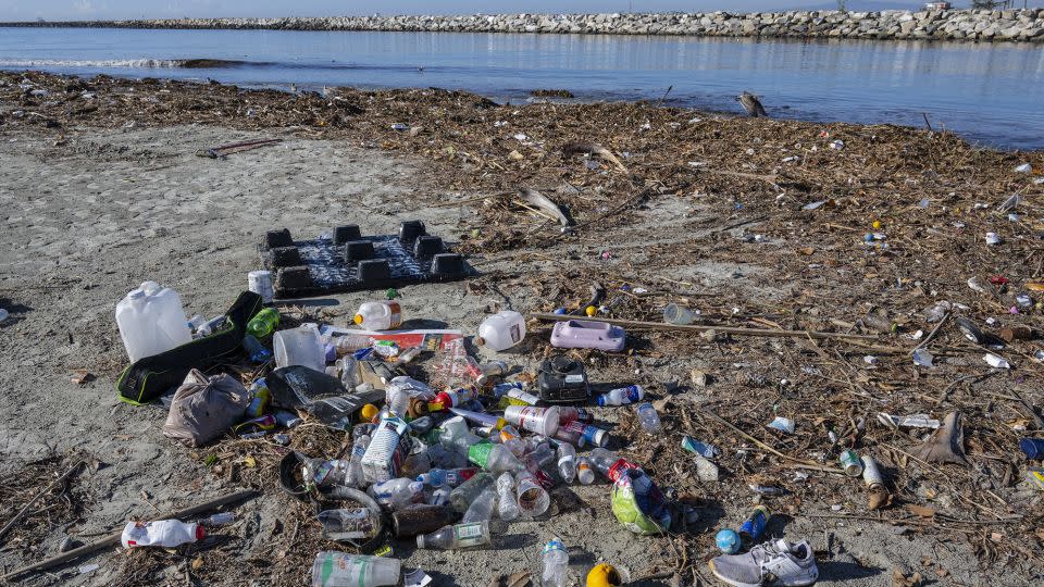 Trash piles up along the bank of the San Gabriel River near the Pacific Ocean in Seal Beach, California. Rains sent the trash flowing down river from miles inland. - Mark Rightmire/MediaNews Group/Orange County Register/Getty Images