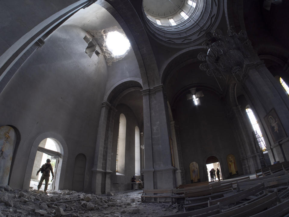 A hole made by shell in the roof of the Holy Savior Cathedral during a military conflict, in Shushi, outside Stepanakert, self-proclaimed Republic of Nagorno-Karabakh, Thursday, Oct. 8, 2020. Armenia accused Azerbaijan of firing missiles into the capital of the separatist territory of Nagorno-Karabakh, while Azerbaijan said several of its towns and its second-largest city were attacked. (AP Photo)