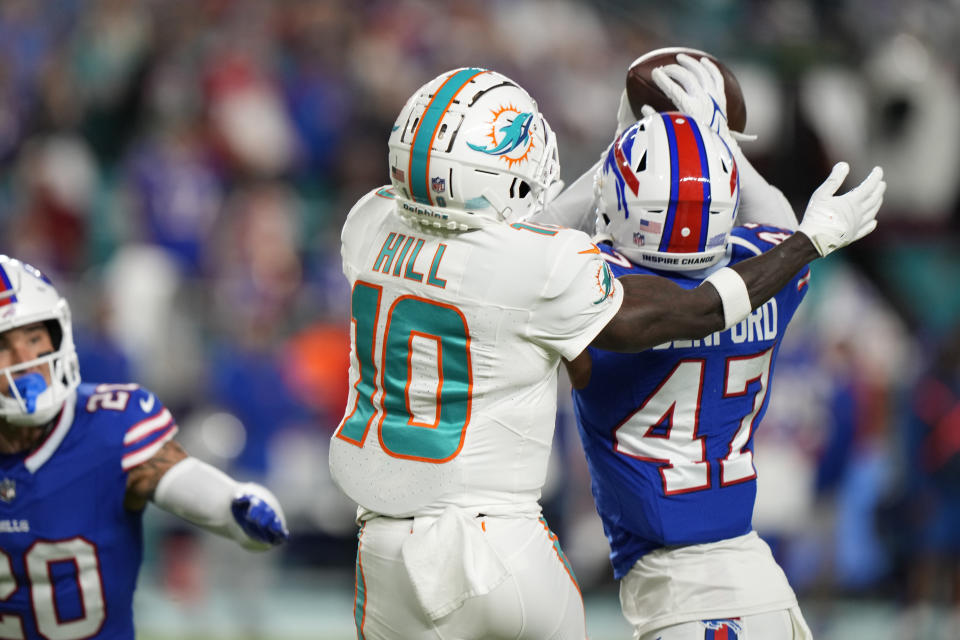 Buffalo Bills cornerback Christian Benford (47) intercepts a pass intended for Miami Dolphins wide receiver Tyreek Hill (10) during the first half of an NFL football game, Sunday, Jan. 7, 2024, in Miami Gardens, Fla. (AP Photo/Wilfredo Lee)