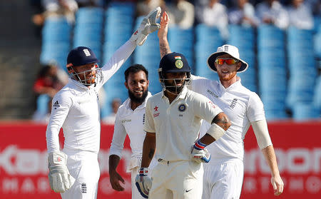 Cricket - India v England - First Test cricket match - Saurashtra Cricket Association Stadium, Rajkot, India - 12/11/16. England's Adil Rashid (2nd L) celebrates after dismissing India's Virat Kohli (2nd R). REUTERS/Amit Dave