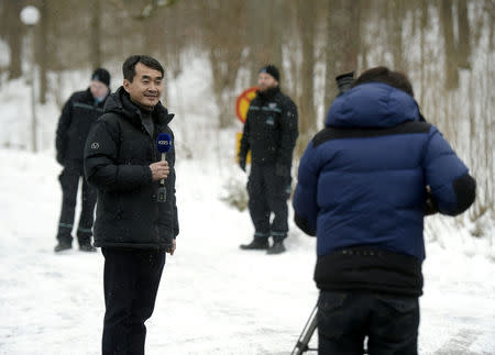 A reporter of Korean Broadcasting System KBS speaks to the camera outside the Finnish government's Koenigstedt Manor in Vantaa, Finland, March 20, 2018. Lehtikuva/Vesa Moilanen via REUTERS