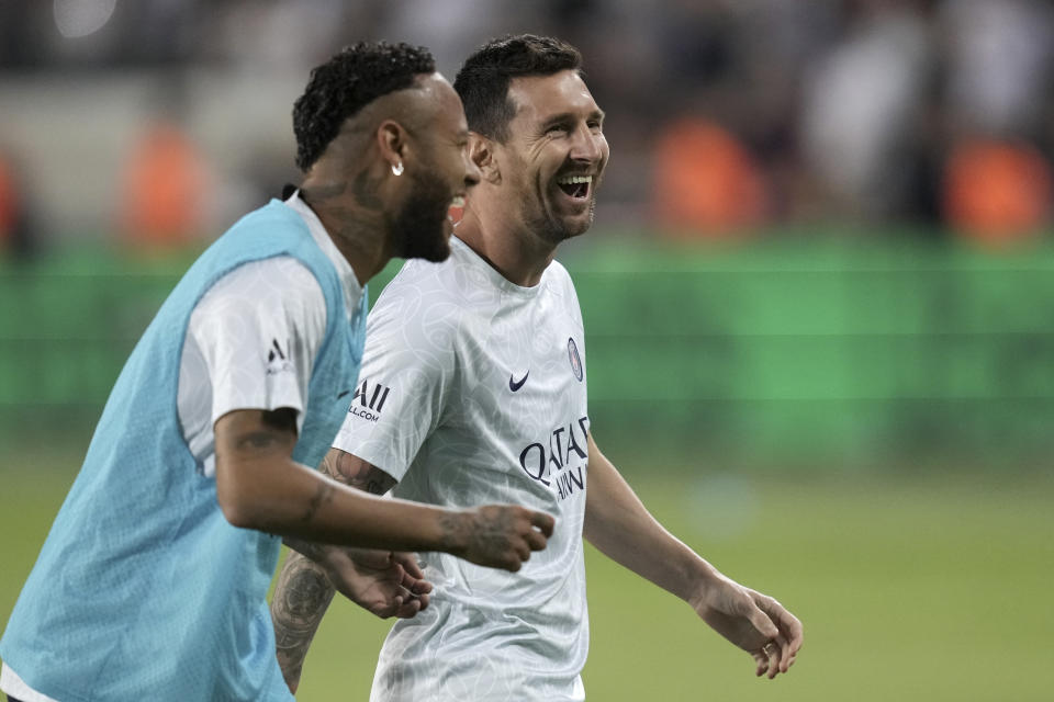PSG's Neymar, left, smiles with his teammate Lionel Messi prior to the start of the French Super Cup final soccer match between Nantes and Paris Saint-Germain at Bloomfield Stadium in Tel Aviv, Israel, Sunday, July 31, 2022. (AP Photo/Ariel Schalit)