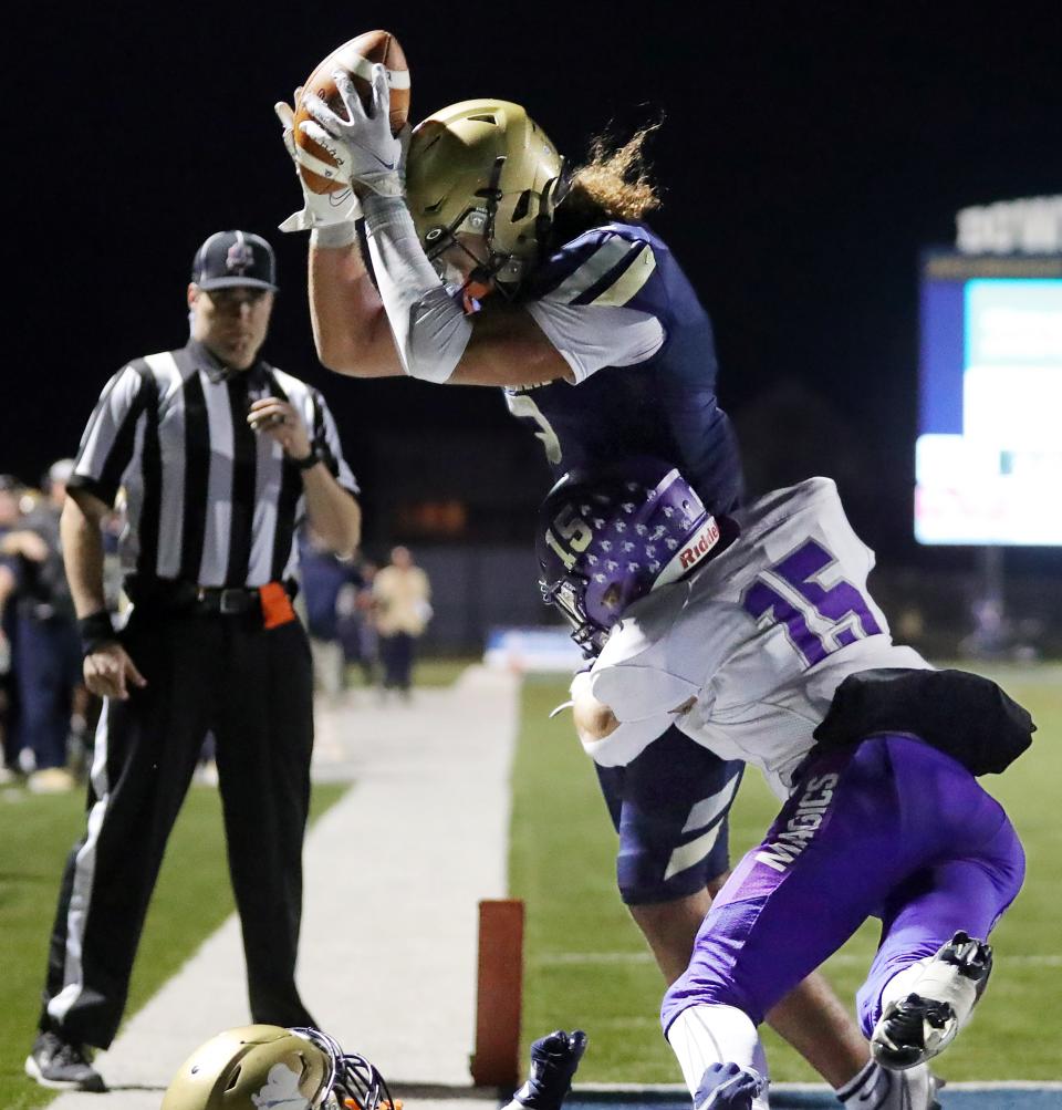 Hoban linebacker Jayvian Crable intercepts a tipped pass in the end zone intended for Barberton wide receiver Noah Dehart during the second half of a Division II playoff football game, Friday, Nov. 4, 2022, in Akron, Ohio.
