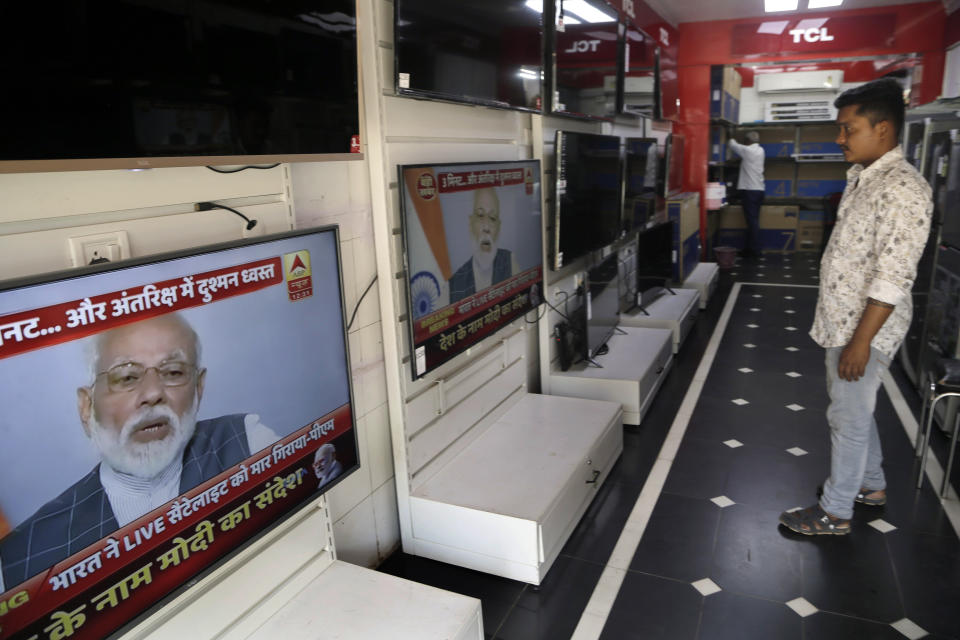 A salesman watches Indian prime minister Narendra Modi addressing the nation on a television in Mumbai, India, Wednesday, March 27, 2019. India says it has successfully tested an anti-satellite weapon in an unexpected announcement just weeks before general elections. Indian Prime Minister Narendra Modi said in an address to the nation broadcast live on Wednesday that Indian scientists had earlier shot down a low earth orbit satellite with a missile, demonstrating India’s capacity as a “space power” alongside the U.S., Russia and China. (AP Photo/Rajanish Kakade)