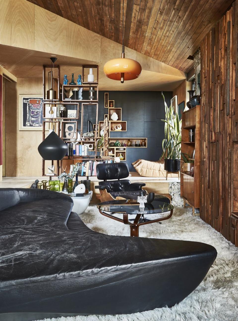 a living room with a black sofa and a table