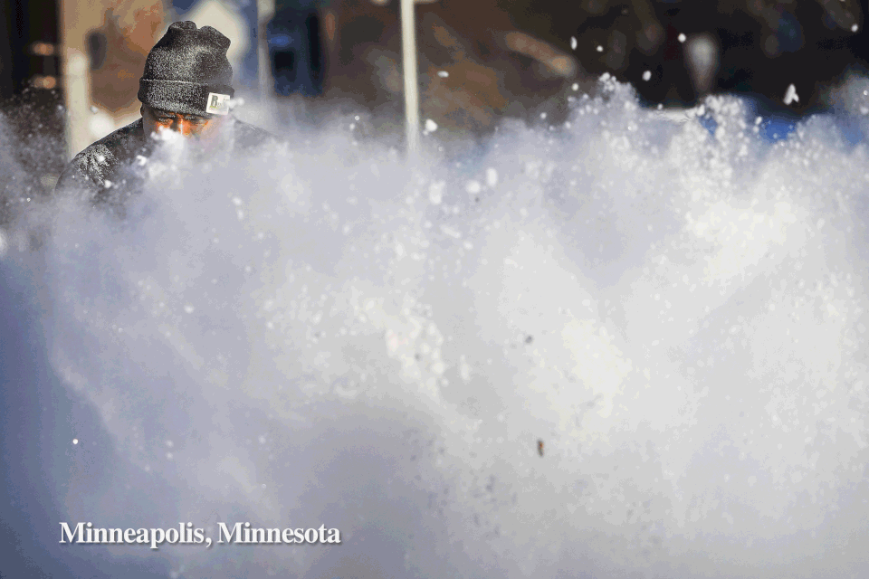 Javier Galicia clears snow from a sidewalk along 4th Ave. in Minneapolis and Angelenos reflected in a glass facade in dtla