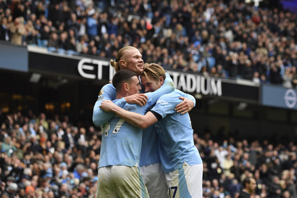 Manchester City's Erling Haaland celebrates with his teammates after scoring his side's second goal during the English Premier League soccer match between Manchester City and and Everton, at the Etihad stadium in Manchester, England, Saturday, February 10, 2024. (AP Photo/Rui Viera)