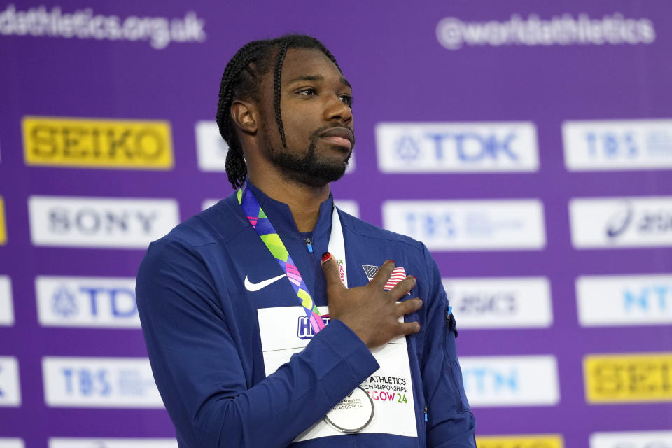 FILE - Silver medalist Noah Lyles, of the United States, stands on the podium of the men's 60 meters during the World Athletics Indoor Championships at the Emirates Arena in Glasgow, Scotland, March 2, 2024. There is one more item to scratch off the list before everyone from Sha’Carri Richardson to Lyles to Sydney McLaughlin-Levrone embark on their trips to Paris for the Olympics: Making the Olympic team. US track trials start Frida, June 21, 2024.(AP Photo/Bernat Armangue, File)