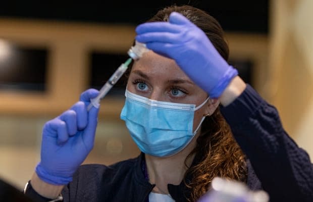 Registered nurse Sarah Moslehi prepares a dose of the Pfizer-BioNTech COVID-19 vaccine at a temporary clinic in Toronto. (Evan Mitsui/CBC - image credit)