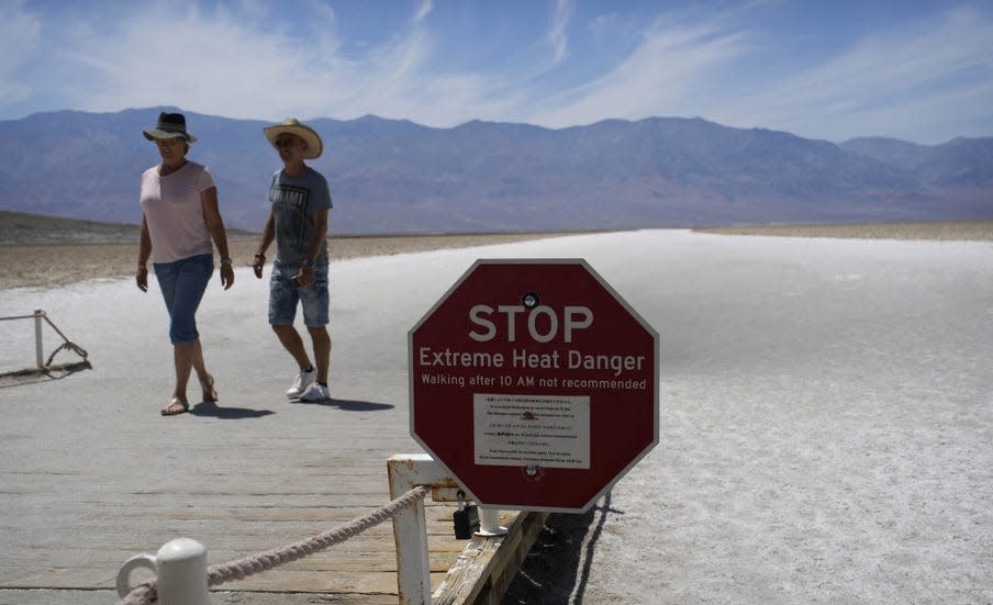 A sign warns visitors of extreme heat danger at Death Valley National Park's Bad Water Basin on Sunday, July 16, 2023.