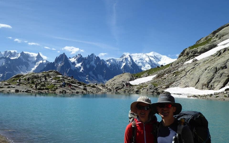 Ms Dingley poses with her partner, Dan Colegate, in front of a lake - Facebook