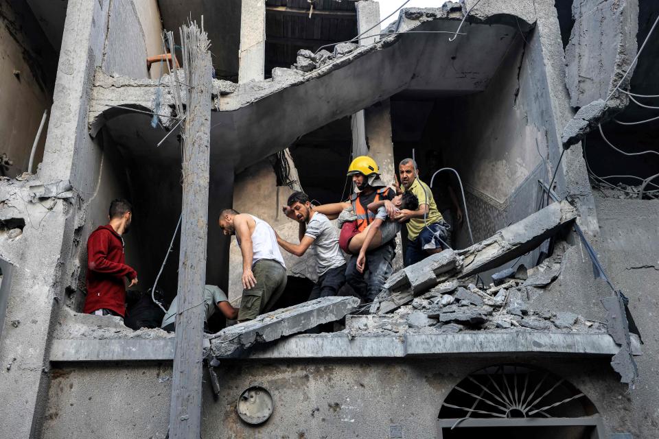 A Palestinian youth is carried out on a stretcher after being rescued from a building hit by Israeli bombardment on Oct. 19, 2023.