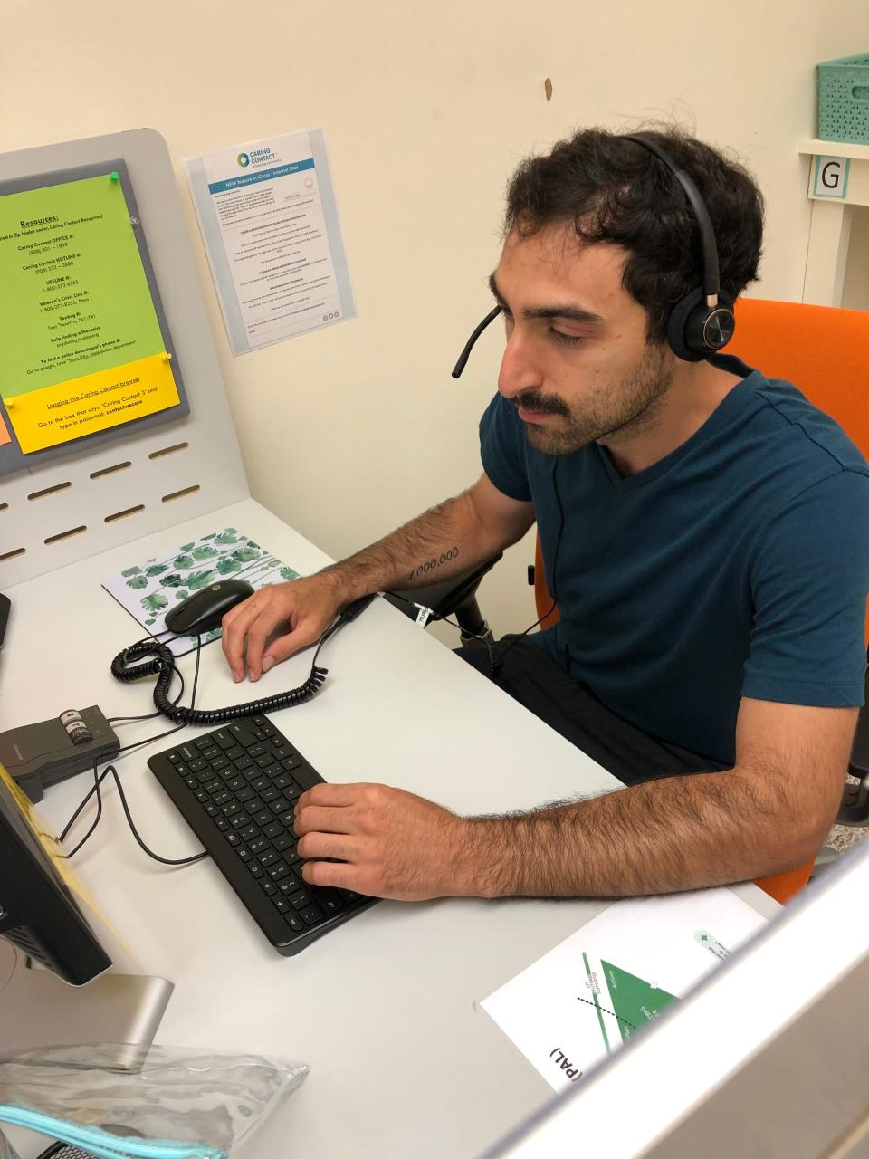 Kevin Parsi sits in the call room of Caring Contact, one of five crisis call centers that will be available by dialing 988 and backed up by the National Suicide Prevention Lifeline Network.