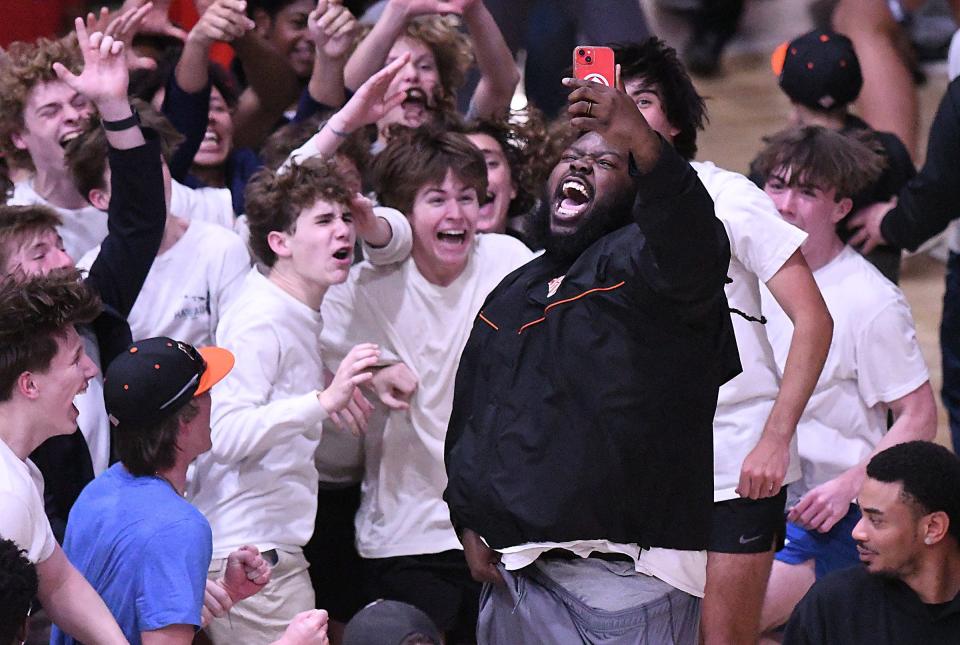 New Hanover players and fans storm the court to celebrate Friday March 8, 2024 at Brogden Hall after they beat Panther Creek 63-61 in the regional semifinal. KEN BLEVINS/STARNEWS