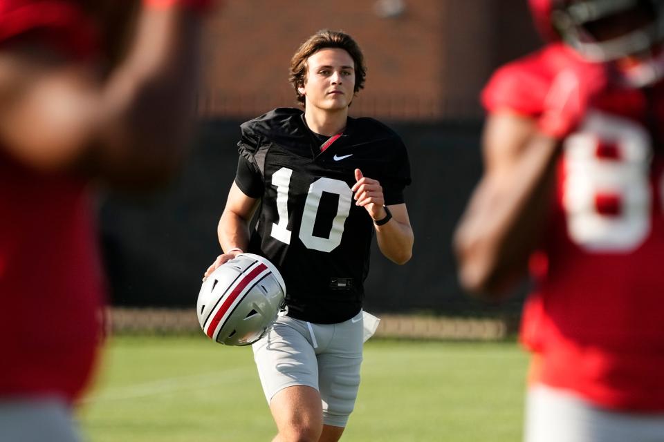 Aug 1, 2024; Columbus, OH, USA; Ohio State Buckeyes quarterback Julian Sayin (10) runs between drills during football camp at the Woody Hayes Athletic Complex.