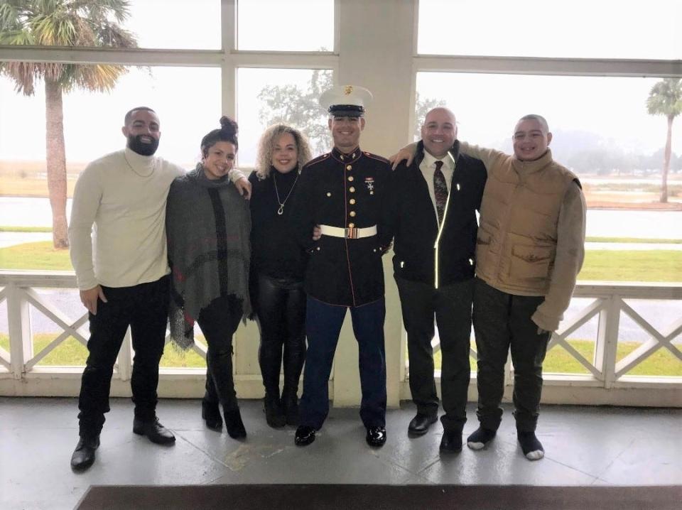 Alec Cruz (center), a Deltona High School graduate, is pictured with his older brother, Nicholas, older sister Alexis, mother Michelle, father Albert and younger brother Seth. Cruz, who is stationed in Hawaii, was recently honored as USO Marine of the Year.