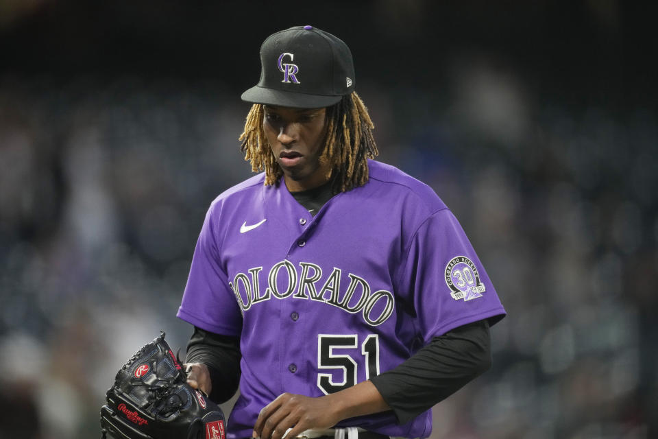 Colorado Rockies starting pitcher Jose Urena heads to the dugout adftger being pulled from the mound in the third inning of a baseball game against the Washington Nationals, Friday, April 7, 2023, in Denver. (AP Photo/David Zalubowski)