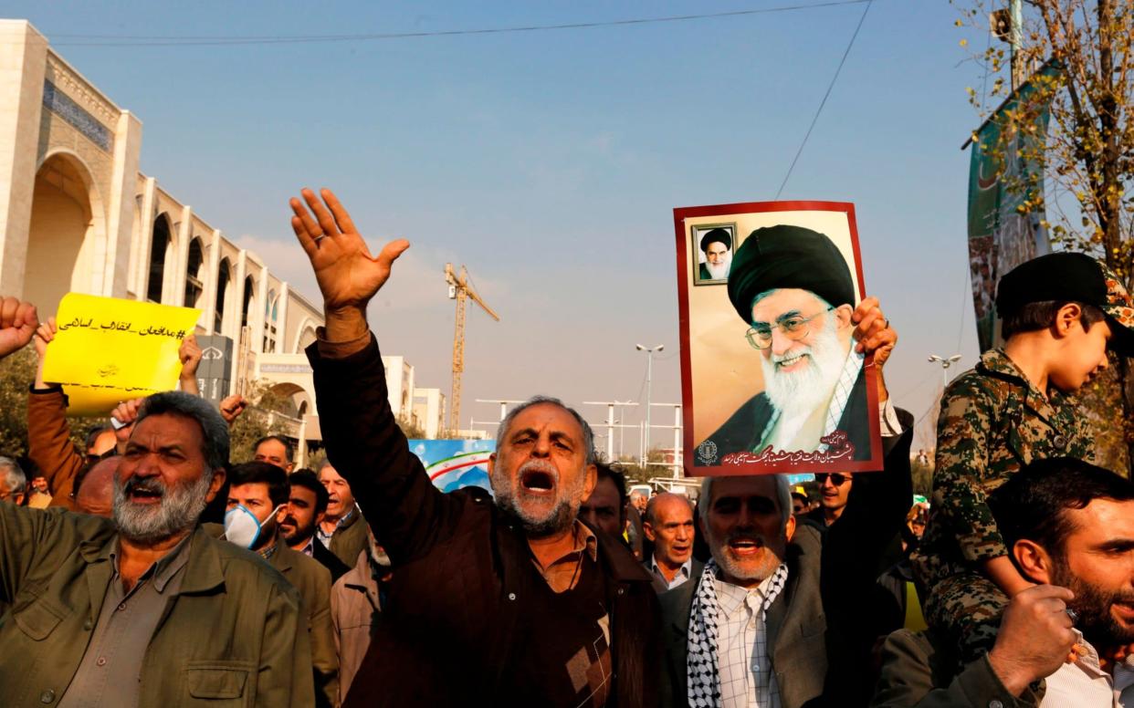 Pro-government demonstrators hold a poster of Iran's supreme leader Ayatollah Ali Khamenei - AFP