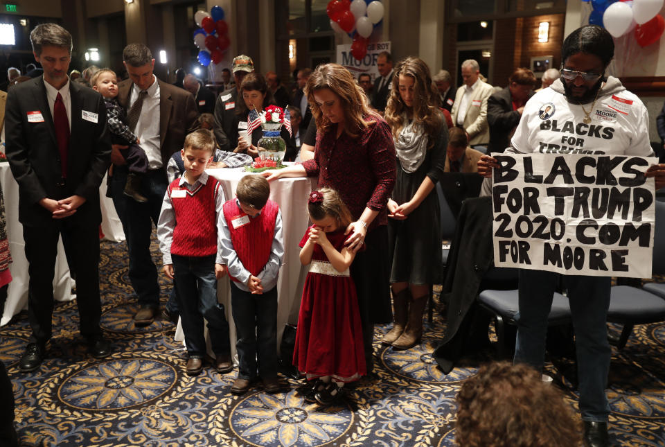 Supporters pray Tuesday during the invocation at Republican U.S. Senate candidate Roy Moore's election night party in Montgomery, Alabama. (Photo: Carlo Allegri / Reuters)