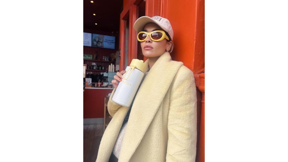 Rita Ora poses in yellow sunglasses