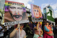 <p>Revelers holds posters depicting U.S. President Trump, and Russian President Vladimir Putin, left, as they march during the annual Gay Pride Parade in Sao Paulo, Brazil, on June 18. (Photo: Nelson Antoine/AP) </p>