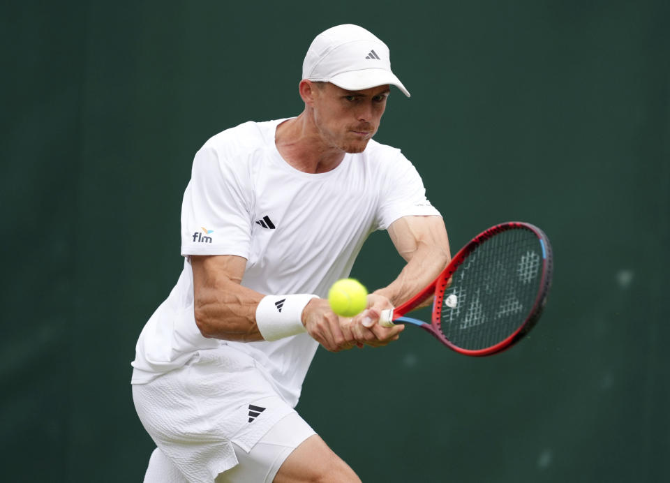 Britain's Billy Harris returns a shot to Spain's Jaume Munar during their men's singles first round tennis match on day two of the Wimbledon tennis championships in London, Tuesday, July 2, 2024. (John Walton/PA via AP)