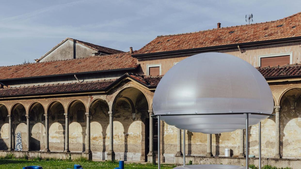 a large white dome with blue buckets in front of it