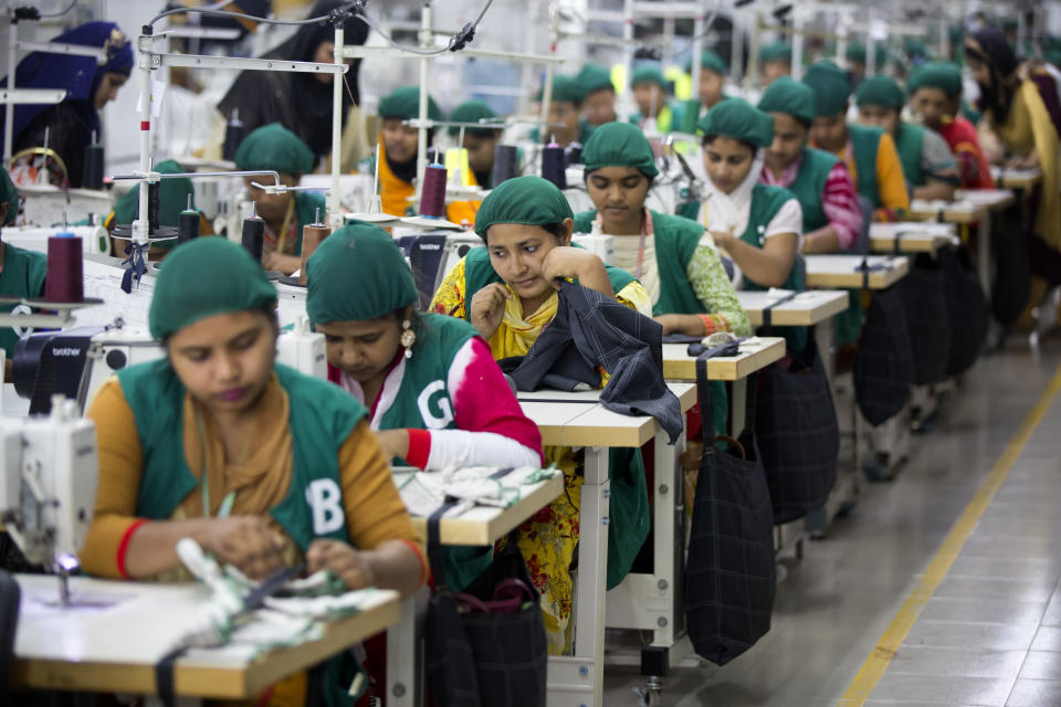 FILE - Trainees work at Snowtex garment factory in Dhamrai, near Dhaka, Bangladesh, April 19, 2018. Bangladesh's economic miracle is under severe strain as fuel price hikes amplify public frustrations over rising costs for food and other necessities. (AP Photo/A.M. Ahad, File)