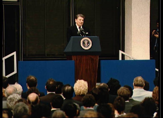 President Ronald Reagan tells a large turnout of JSC employees and family and friends of the 51-L crewmembers about their accomplishments and sacrifices during memorial services held following the Challenger accident at Kennedy Space Center (KSC)."They slipped the surly bonds of earth to touch the face of God" the President told the thousands gathered on the central mall at JSC. (NASA)