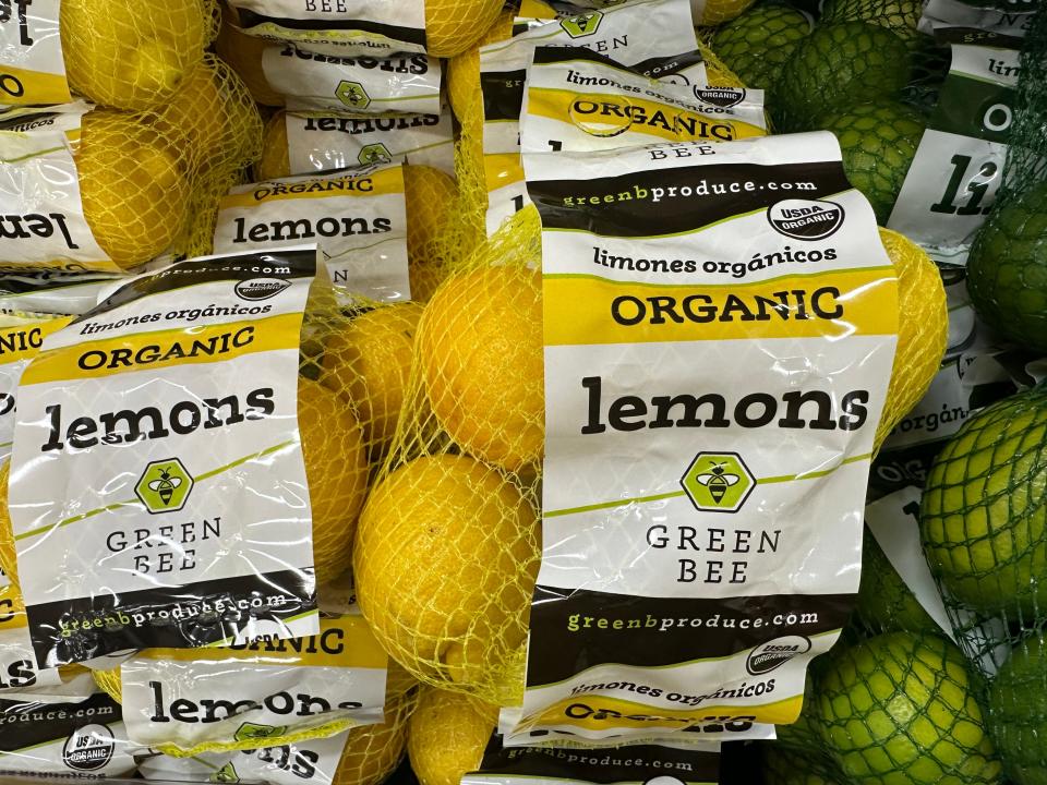 bags of trader joe's organic lemons next to bags of limes