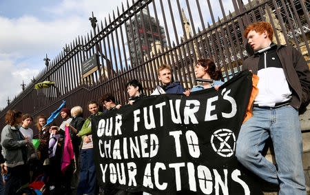 FILE PHOTO: Climate change activists lock themselves at the gate of the Houses of Parliament during an Extinction Rebellion protest in London, Britain May 3, 2019. REUTERS/Toby Melville/File Photo