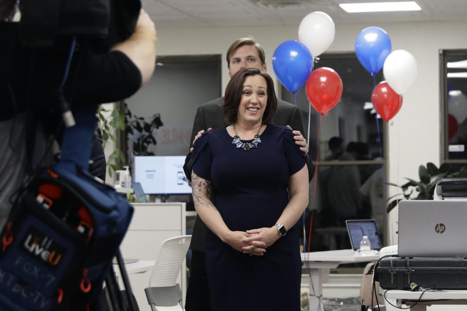 Democratic U.S. Senate candidate MJ Hegar stands with her husband, Brandon Hegar, as she waits to speak at her election night party in Austin, Texas, Tuesday, March 3, 2020. (AP Photo/Eric Gay)