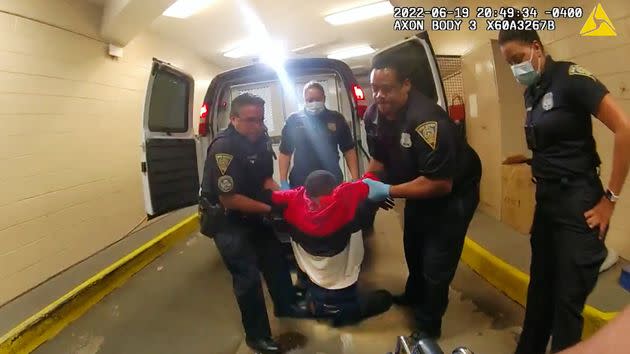 A still from police body camera video shows Cox being pulled from the back of a police van and then placed in a wheelchair after being detained by New Haven Police. (Photo: New Haven Police via Associated Press)