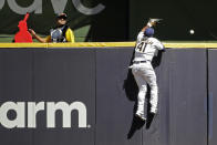 Milwaukee Brewers' Jackie Bradley Jr. is unable to make a catch at the wall on a solo home run hit by Pittsburgh Pirates' Jacob Stallings during the sixth inning of a baseball game Sunday, June 13, 2021, in Milwaukee. (AP Photo/Aaron Gash)