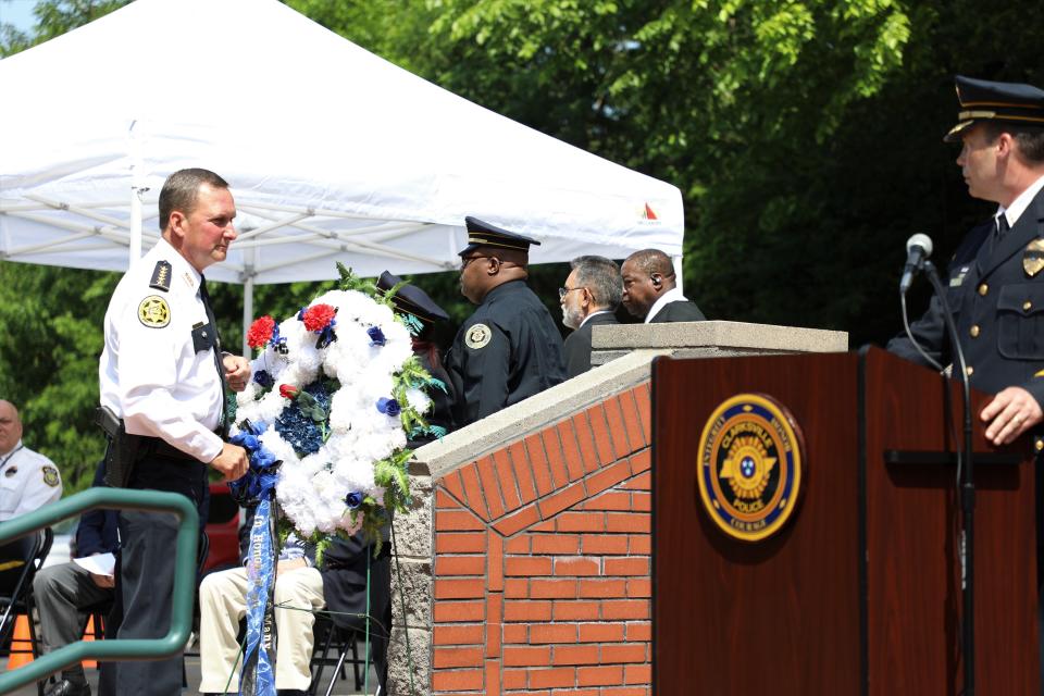 Sheriff John Fuson places a carnation on the wreath in honor of Clarksville-Montgomery County's fallen law enforcement officers.