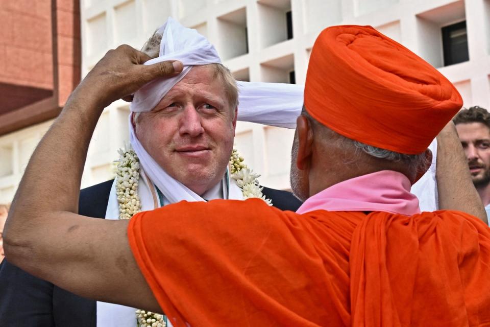 MrJohnson gets a traditional turban upon his arrival at the Gujarat Biotechnology University in April (POOL/AFP via Getty)