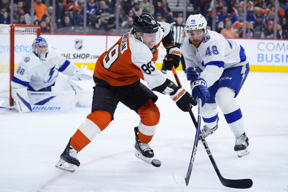 Tampa Bay Lightning's Nick Perbix, right, clears the puck away from Philadelphia Flyers' Cam Atkinson during the second period of an NHL hockey game, Tuesday, Jan. 23, 2024, in Philadelphia. (AP Photo/Matt Slocum)