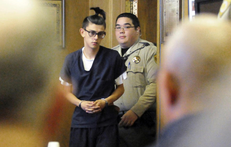 FILE - In this Aug. 31, 2017, file photo, Nathaniel Ray Jouett, accused of fatally shooting two workers inside a public library and wounding four others, enters a courtroom in Clovis, N.M. Authorities say Jouett, then 17, who opened fire at a rural New Mexico library last year will plead guilty. The August, 2017 shooting killed two librarians and injured four others. District Attorney Andrea Reeb said Tuesday, Oct. 2, 2018 that Jouett has agreed to plead guilty to 30 counts listed in an indictment filed against him, including two counts of first-degree murder. (Tony Bullocks/The Eastern New Mexico News via AP, File)