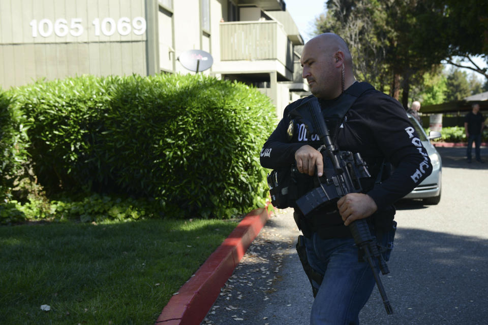 Police approach the apartment complex believed to be associated with a car crash suspect in Sunnyvale, Calif., on Wednesday, April 24, 2019. Investigators are working to determine the cause of a crash in Northern California that injured eight pedestrians on Tuesday evening. Authorities say the driver of a car was taken into custody after he appeared to deliberately plow into them. (AP Photo/Cody Glenn)